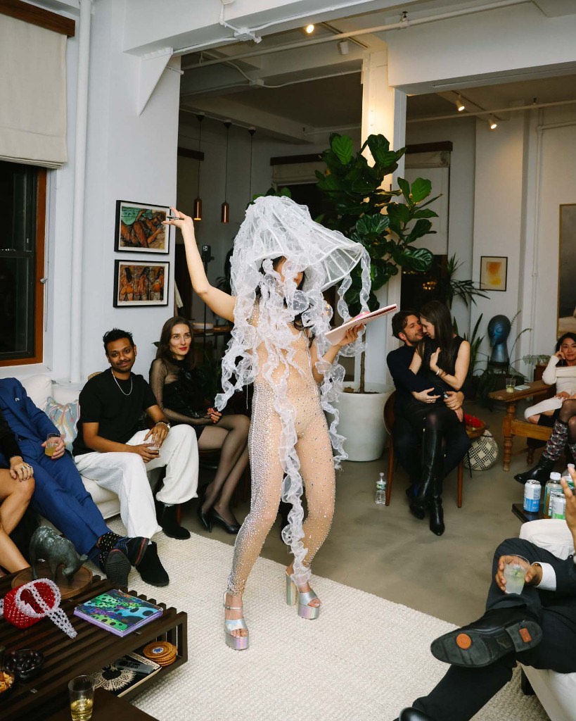 A performer surrounded by Velvet Ties members as a couple connects at an IRL gathering