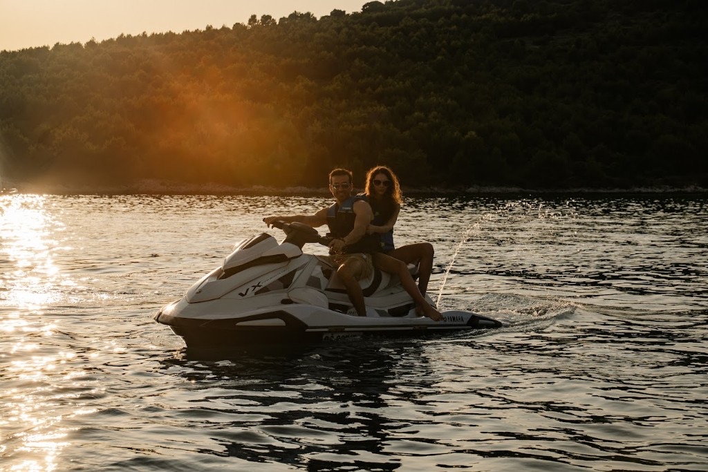 Velvet Ties members on the water at golden hour