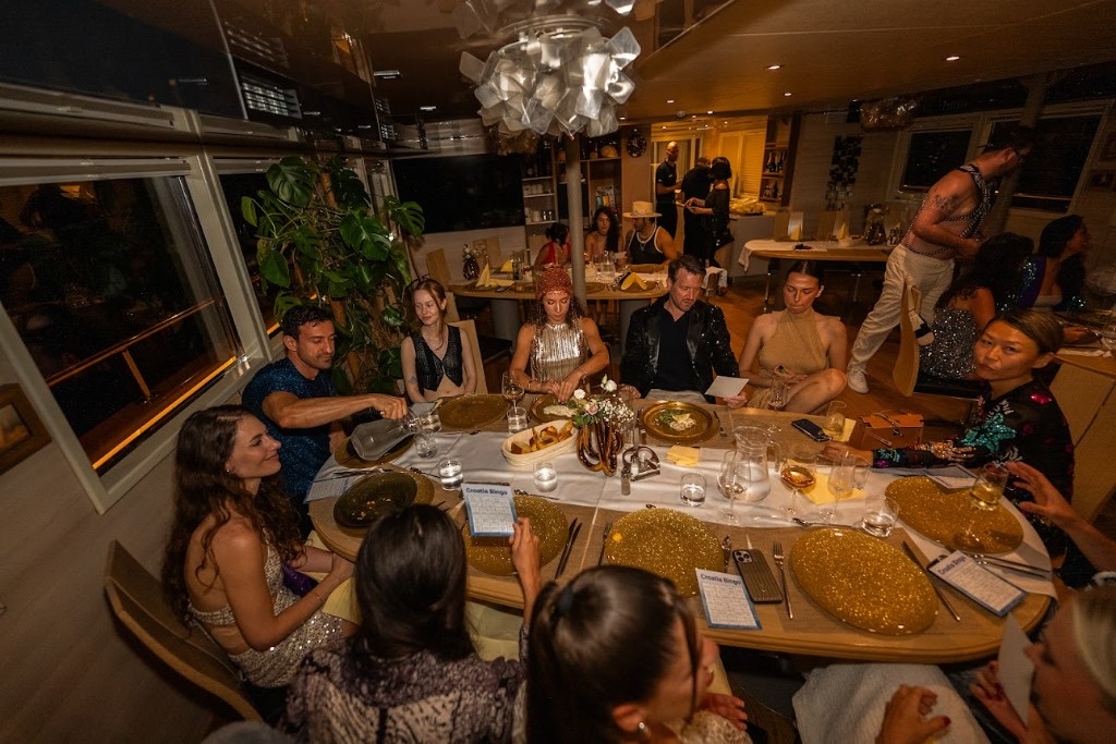 Velvet Ties members at a warm group dinner aboard a yacht
