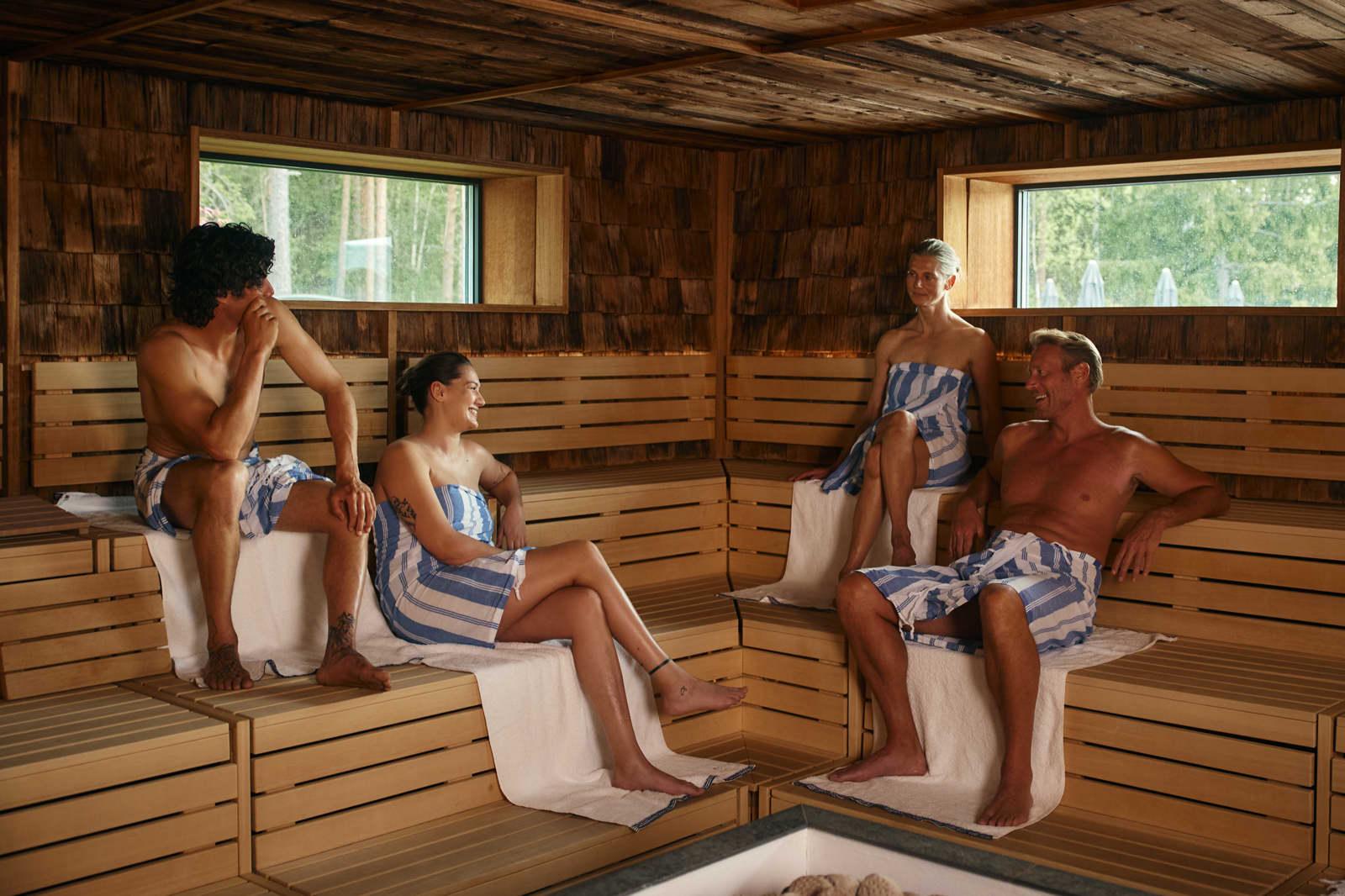 Guests in the forest sauna at The Well