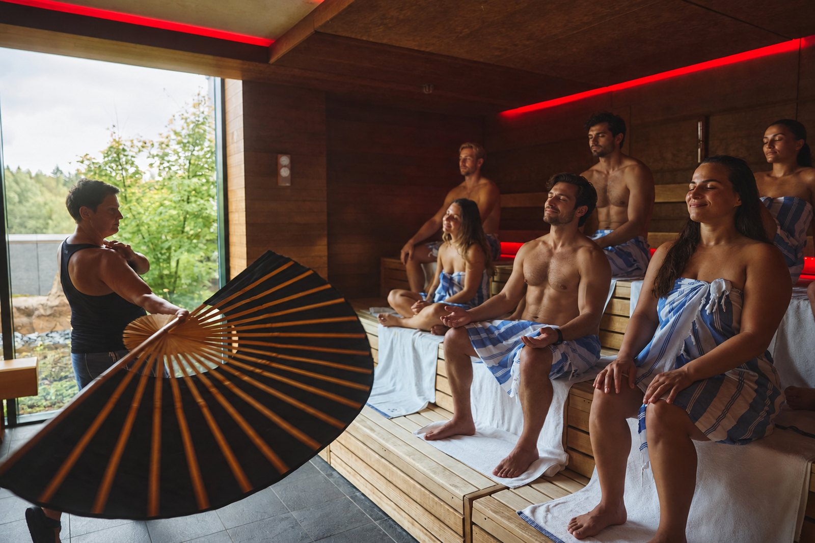 Sauna master fanning heat during an aufguss ritual